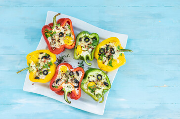 Peppers stuffed with rice and cheese, vegetarian food, wooden background, top view