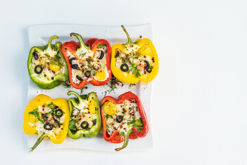 Peppers stuffed with rice and cheese, vegetarian food, wooden background, top view