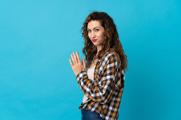 Fototapeta premium Young caucasian woman isolated on blue background scheming something