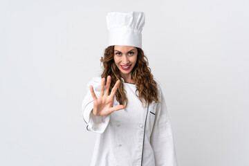 Young chef woman isolated on white background counting five with fingers