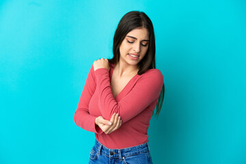 Young caucasian woman isolated on blue background with pain in elbow