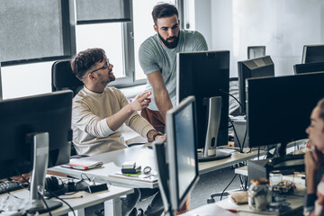 Two programmers at the office.They discuss and working on new project.	

