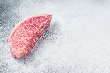 Raw wagyu rump sirloin steak, kobe beef meat. White background. Top view. Copy space