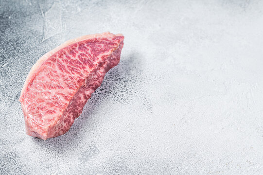 Raw Wagyu Rump Sirloin Steak, Kobe Beef Meat. White Background. Top View. Copy Space