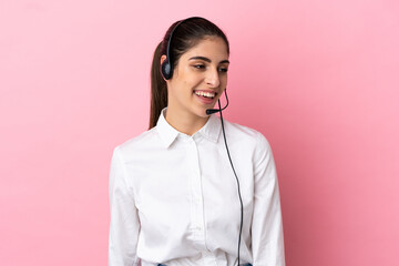 Young telemarketer over isolated background looking to the side and smiling