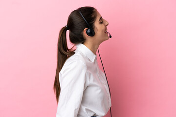 Young telemarketer over isolated background laughing in lateral position - obrazy, fototapety, plakaty