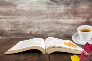 Blank journal on a rustic wooden table with a cup of tea, fall