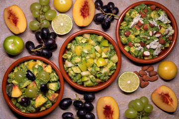 Set of chunky guacamole avocado dip assortment of various kinds with different ingredients: fruits, nuts and cheese top view.