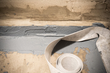 Applying a waterproofing tape to the joint between the wall and the floor. Internal construction...