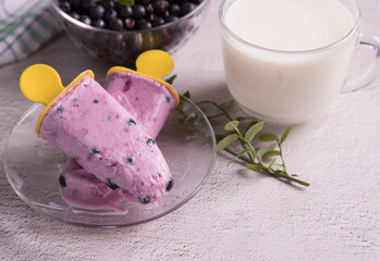 Melting homemade excimo ice cream with berries on a transparent plate.Homemade summer desserts
