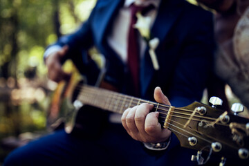 Close up image of man playing guitar