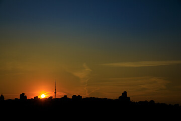 Fototapeta premium Panorama of city buildings at sunrise or sunset, the landscape of the big city with buildings of different heights