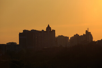 Fototapeta premium Panorama of city buildings at sunrise or sunset, the landscape of the big city with buildings of different heights