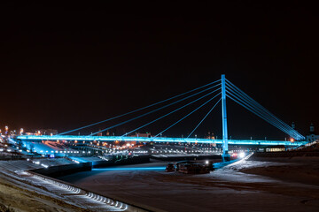 Fototapeta na wymiar Bridge of lovers with blue illumination in Tyumen