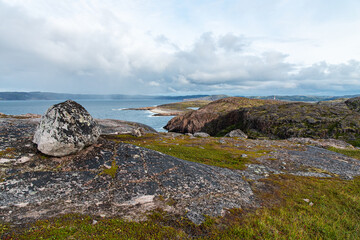 beautiful landscape of the North Sea coast with stones covered with colorful moss. View from the mountain.Teriberka, Barents Sea, Murmansk region, Kola Peninsula