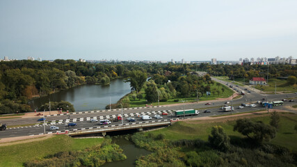Naklejka premium An overpass across the city river. Busy freeway. Aerial photography.