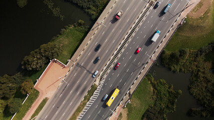An overpass across the city river. Busy freeway. Aerial photography.