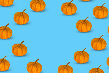 Modern autumn pattern of orange pumpkins on a blue background.