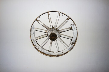 An Old Cart Wheel On The Wall