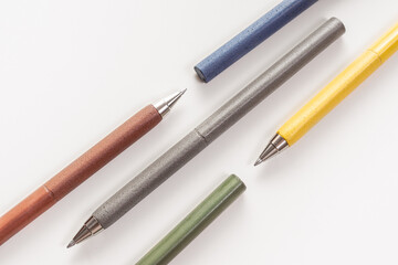 Set of multi-colored pens on white background. Pattern