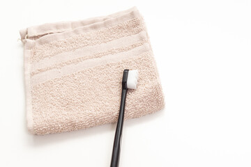 Toothbrush and towel on white background