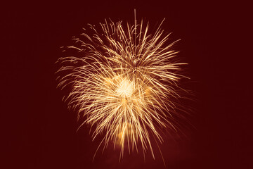 yellow fireworks against red background