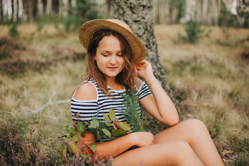 Young girl in the autumn forest. The girl in the hat. heather blooms in autumn