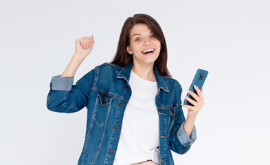 Young woman over isolated white background with phone in victory position