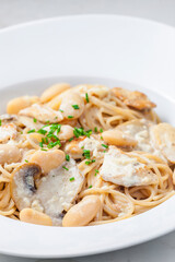 spaghetti with creamy mushroom sauce, chicken and beans