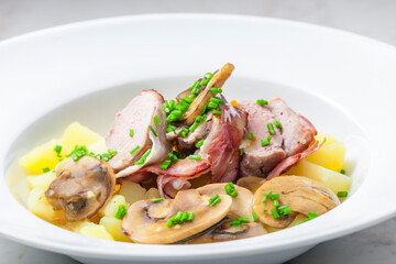 veal roll in bacon with mushroom sauce and potatoes