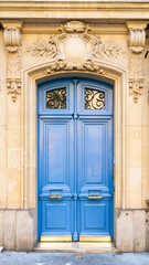 Paris, a blue wooden door, typical building in the center
