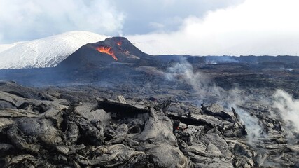Eruption at Fagradalsfjall, Iceland. Erupting vents in the background with red, molten lava,...