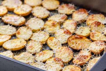 slices of potatoes baked with grated cheese