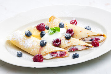 pankaces filled with blueberries, raspberries and cream