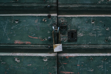 old rusty padlock on wooden door