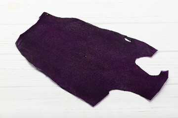 purple natural colored rays leather on the wooden table	
