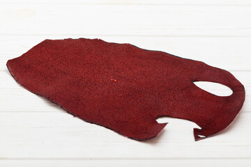 Fototapeta premium Red natural colored rays leather on the wooden table