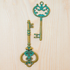 two old vintage keys on wooden background