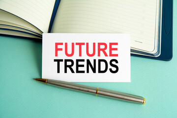 a white card with the text future trends, open paper notebook on background