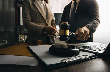 Business and lawyers discussing contract papers with brass scale on desk in office. Law, legal services, advice, justice and law concept picture with film grain effect