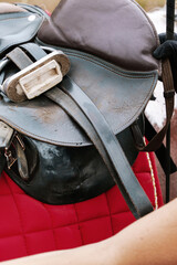Close up detail of worn leather riding saddle