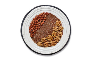 White plate with flax seeds, peanuts and walnuts isolated on white