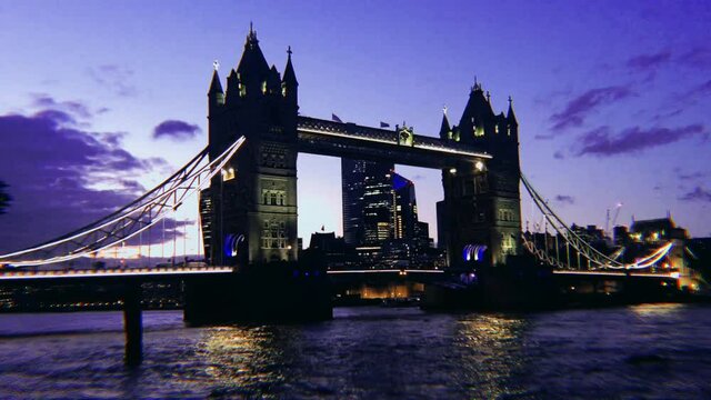  Tower Bridge skyline at sunset with Thames river lights reflected on river, famous London landmark and tourist travel attraction - stock footage video