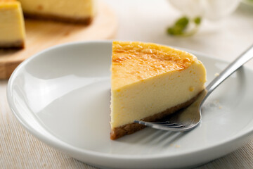 Piece of delicious homemade cheesecake served on a white plate