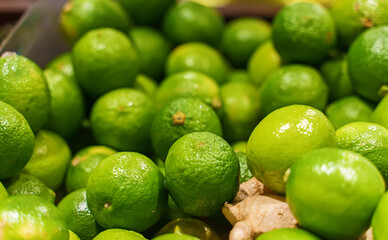 Close-up view of organic limes in the basket.