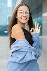 Vaccination, medicine, pandemic and healthcare concept - A pretty oriental woman in casual clothes...