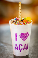 Brazilian açaí frozen in a styrofoam cup with condensed milk and candies. For açaí Lovers.