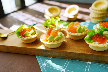 bruschetta with fish and vegetables. Christmas dish on lights background 