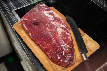 Raw Picanha steak cut on a wooden plate