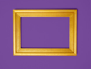 Gold frame on a purple paper background. Holiday background, Halloween, place for text